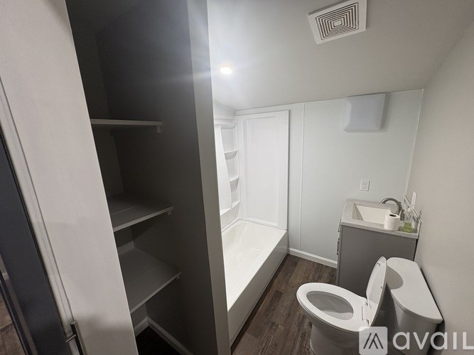 A small bathroom with a toilet, sink, and a pantry.