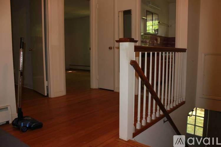 A room with a vacuum cleaner on the floor.