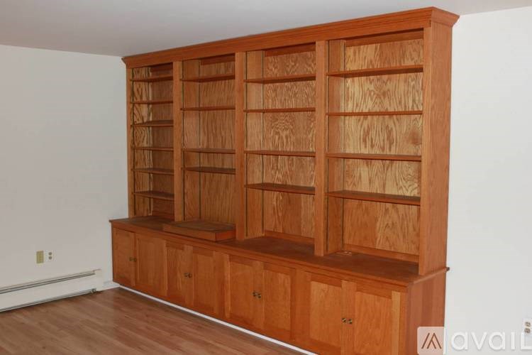 A large wooden bookcase with many compartments.