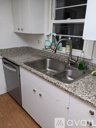 A kitchen with a granite countertop and a dishwasher.