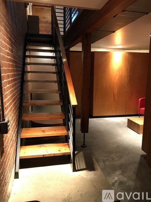 A staircase with wooden steps and a metal railing.