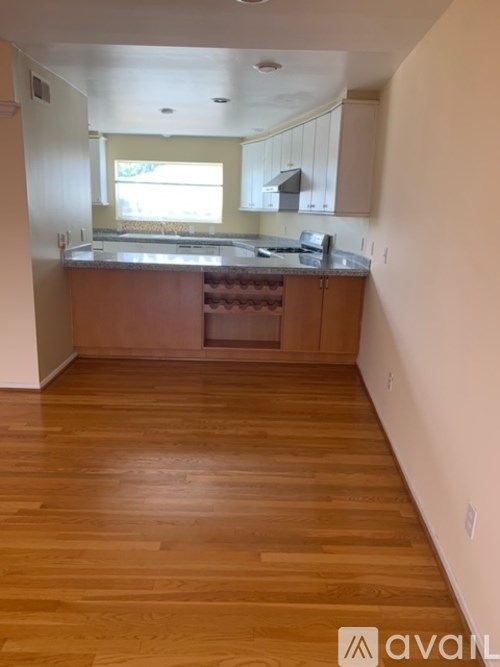 A kitchen with wooden floors and a counter top.