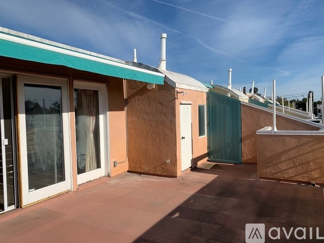 A row of houses with a clear blue sky above them.