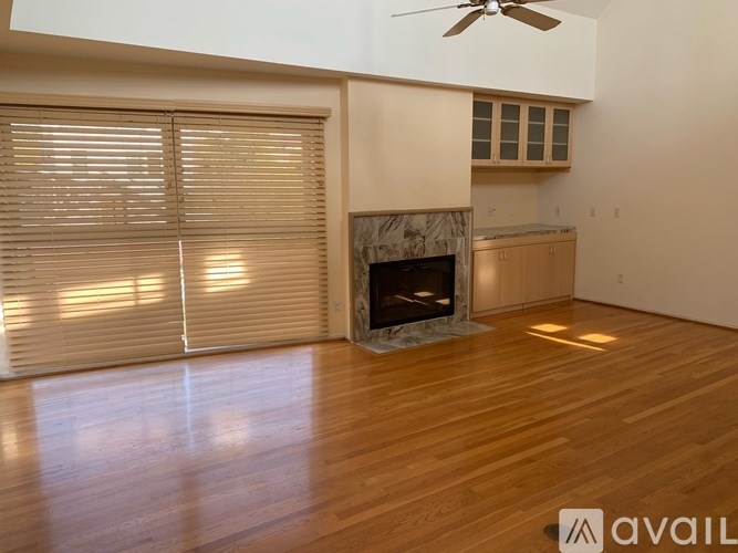 A room with a fireplace and a fan.