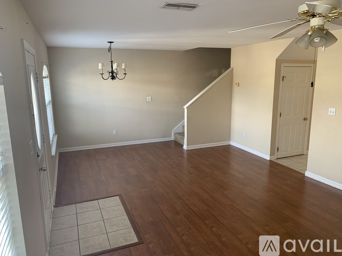A room with wooden floors and a chandelier.