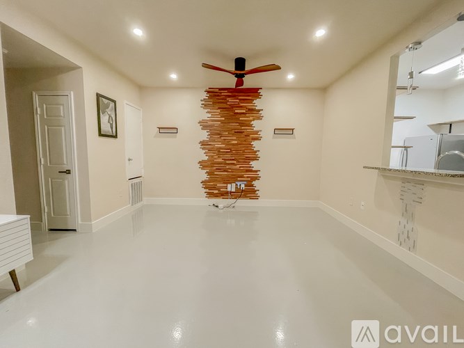 A room with a white ceiling and a wooden spiral staircase.