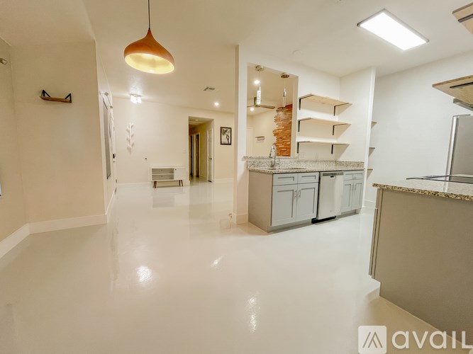 A spacious kitchen with white cabinets and a central island.