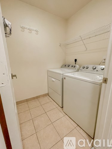A small laundry room with a washer and dryer.