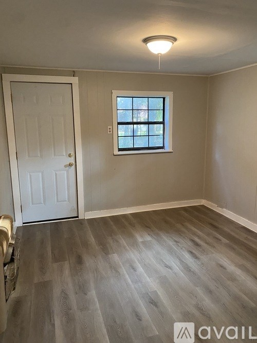 A room with a white door and a window with a white frame.