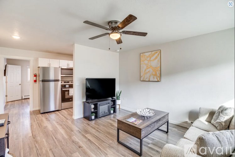 A living room with a television, a couch, and a coffee table.