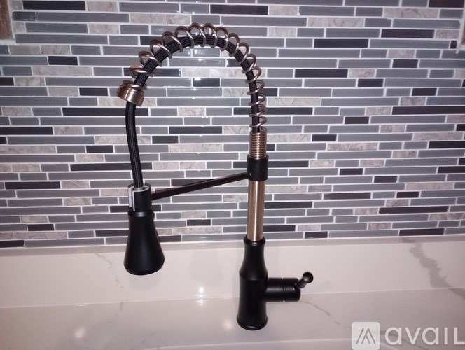 A black bathroom faucet with a curved spout and two handles.