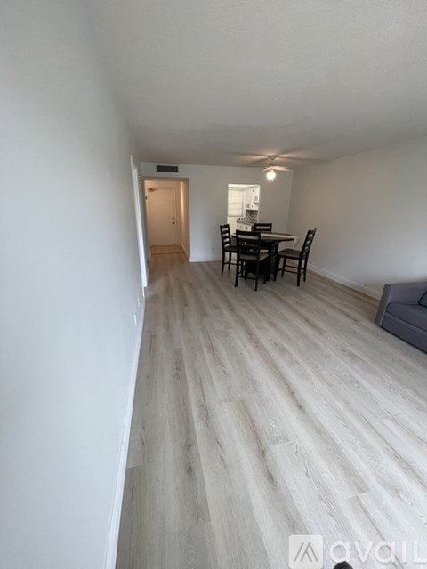 A long hallway with a dining area at the end.