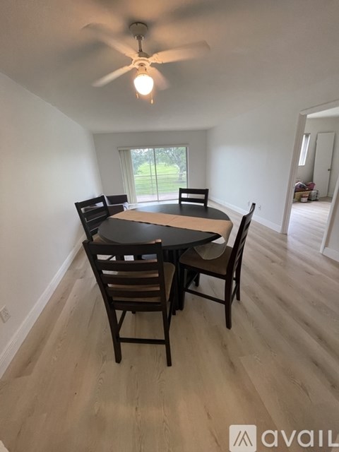 A dining room with a table and chairs.