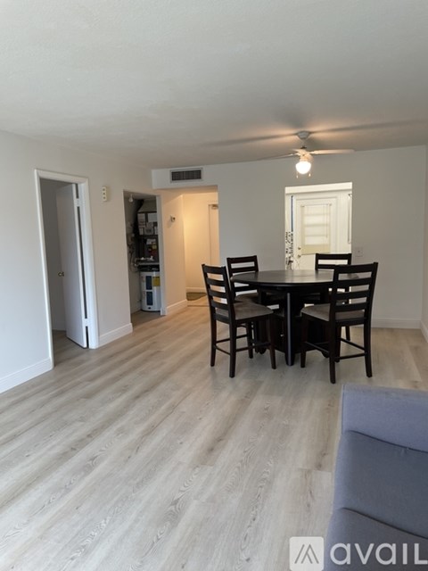 A dining room with a table and chairs.