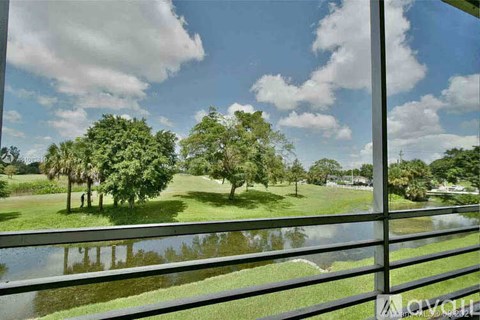 A view of a green field through a window.