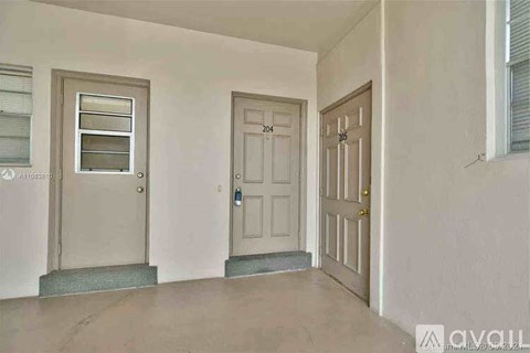 A room with three doors, one of which is open.