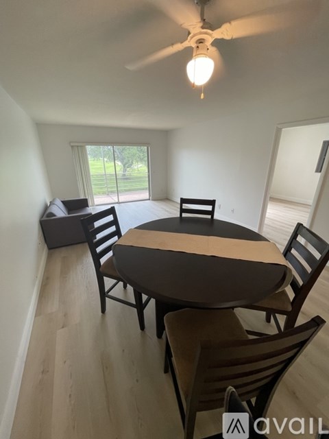 A dining room with a table and chairs.