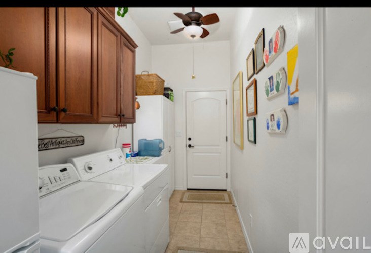 A small laundry room with a washer and dryer.