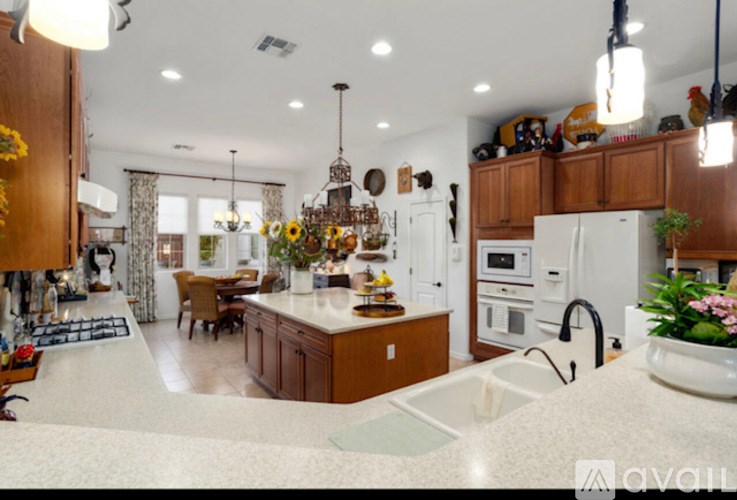 A kitchen with wooden cabinets and a white countertop.