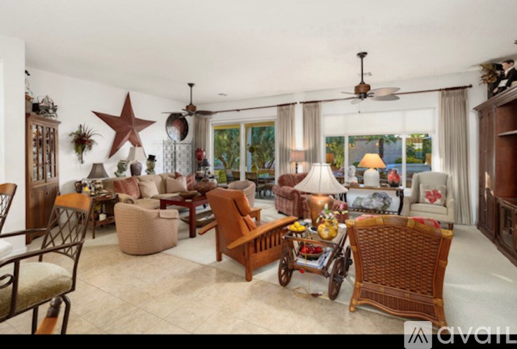 A living room with a variety of furniture including a sofa, chairs, and a table.