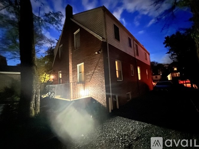 A house is lit up at night with the word "AVAIL" on the bottom right.