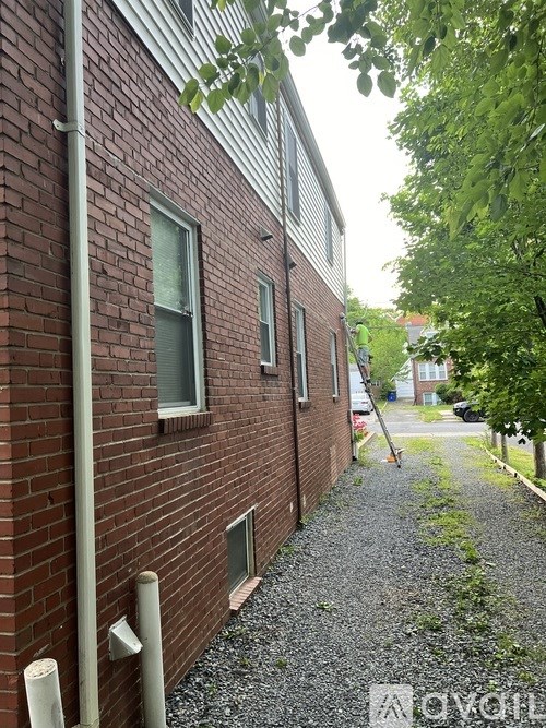 A brick building with a gravel path in front.
