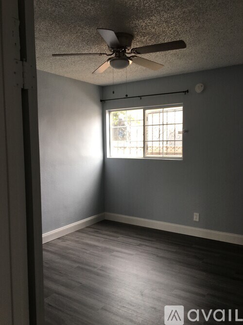 A room with a ceiling fan and a window.