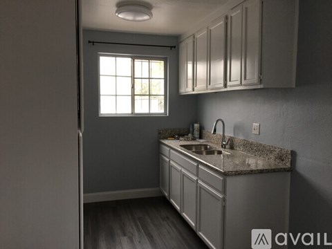 A kitchen with a sink and cabinets.