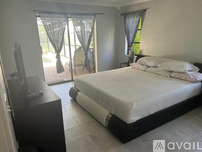 A bedroom with a large bed and a television.