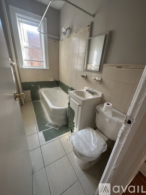 A bathroom with a toilet, sink, and bathtub.