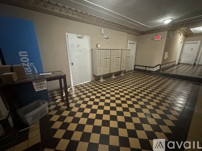 A room with a checkered floor and a white door.