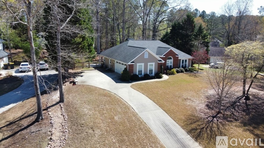 A house with a driveway and a car parked in front.