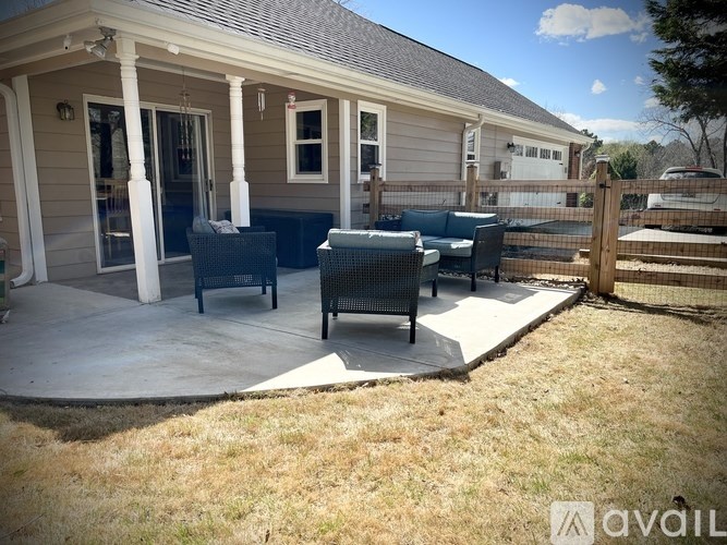 A patio area with a table and chairs outside a house.