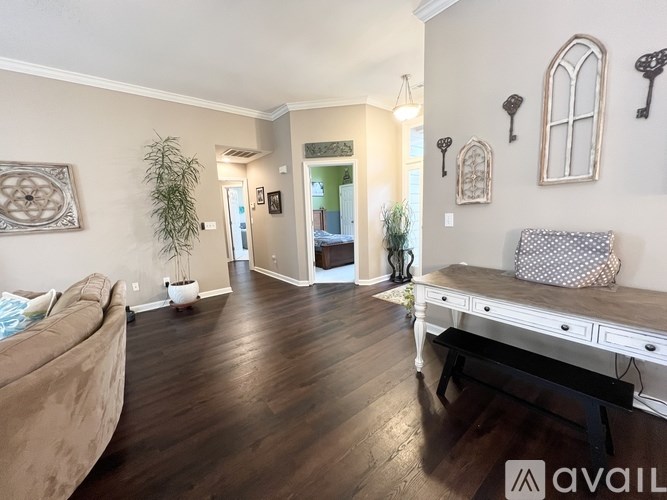 A living room with a couch, a bench, and a plant.