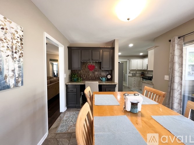 A dining room with a wooden table and chairs.
