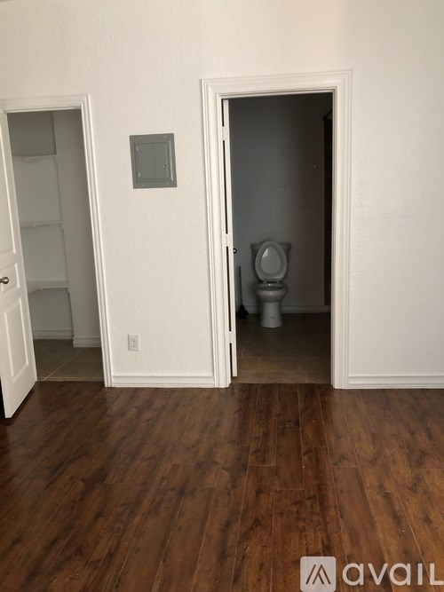 A bathroom with a toilet and a shower stall.