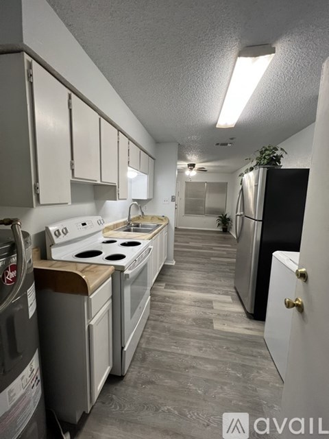 A kitchen with a washing machine and a dishwasher.