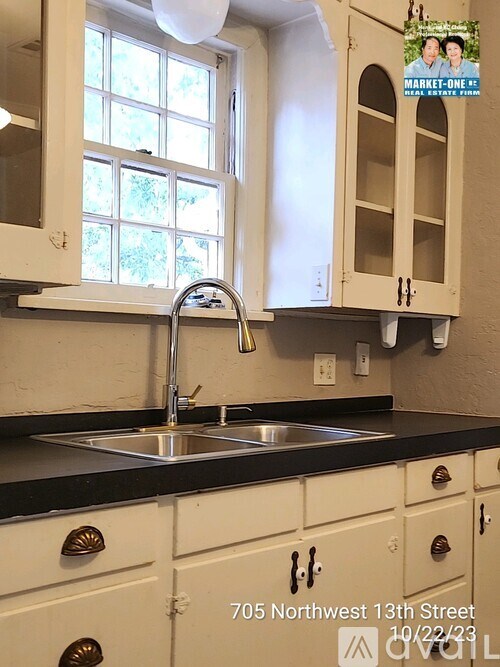 A kitchen with a sink and a window.