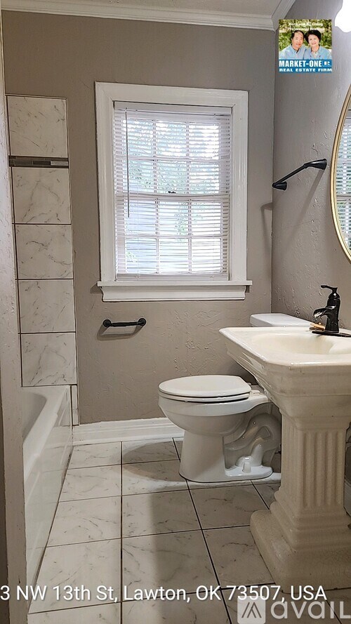 A bathroom with a toilet, sink, and window.