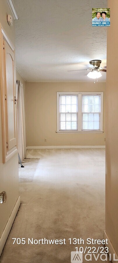 A room with a window and a ceiling fan.