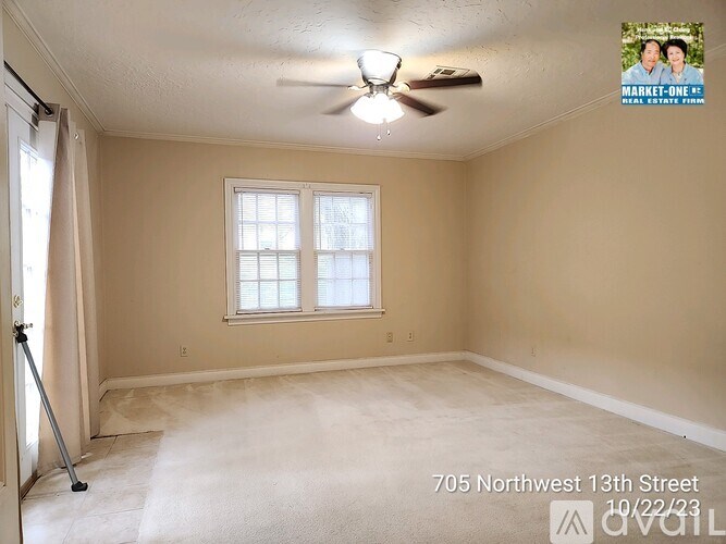 A room with a window and a ceiling fan.