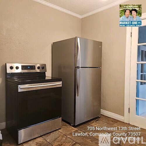A kitchen with a stove, oven and refrigerator in a property located at 705 Northwest 13th Street Lawton, Comanche County 73507 United States.