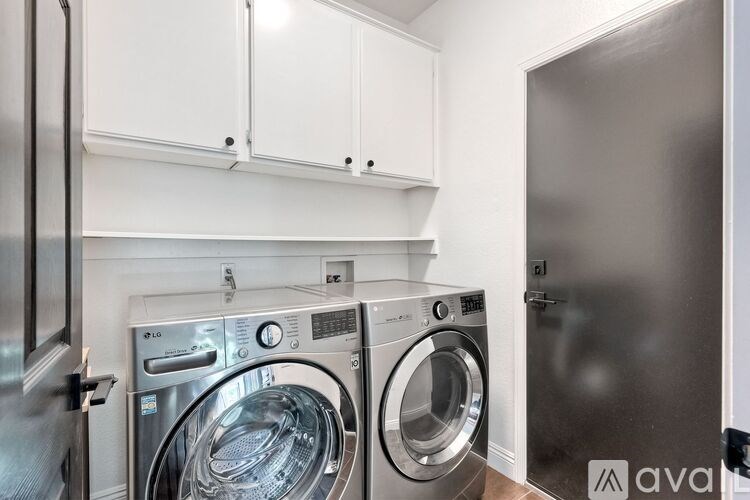 A washing machine and dryer in a laundry room.