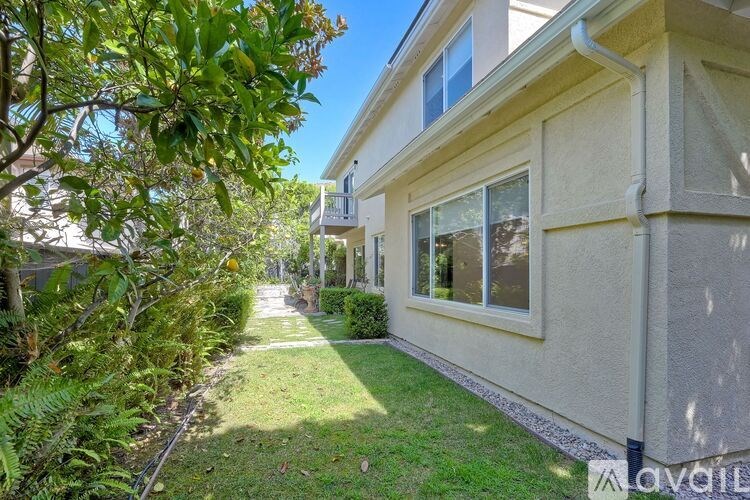 A house with a lawn and trees in front of it.