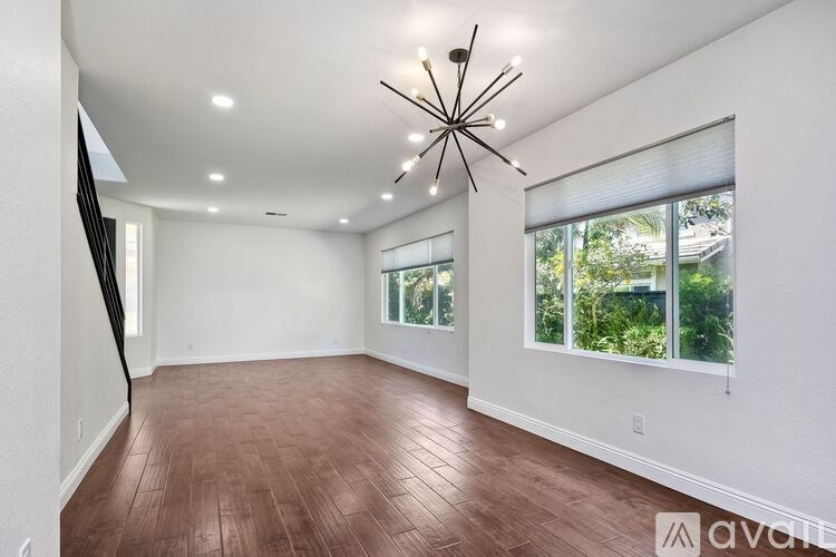 A room with wooden floors and a large window.