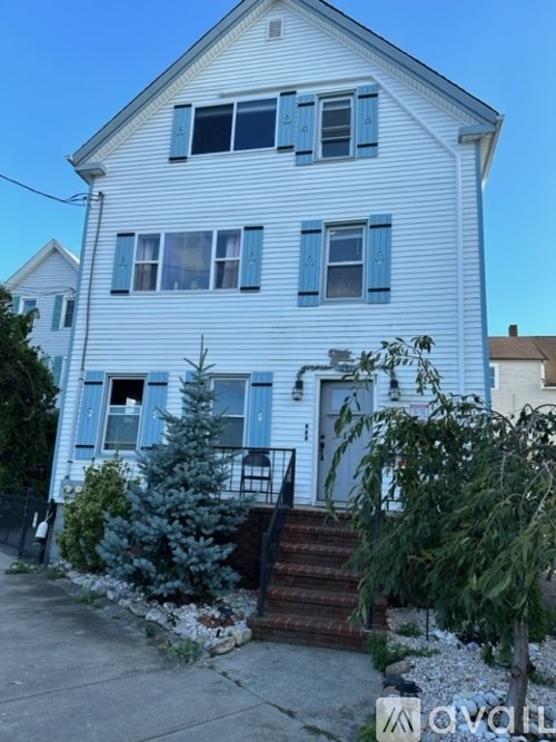 A white house with a blue sky in the background.