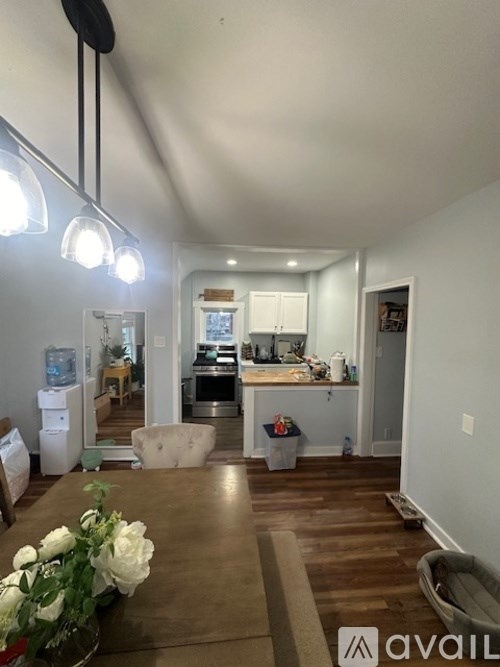 A kitchen area with a dining table and chairs.