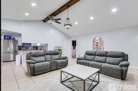 A living room with a grey sofa and a grey coffee table.