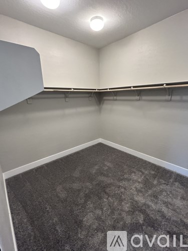 A room with grey carpet and white walls.