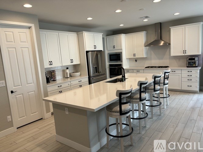 A kitchen with white cabinets and a large island.